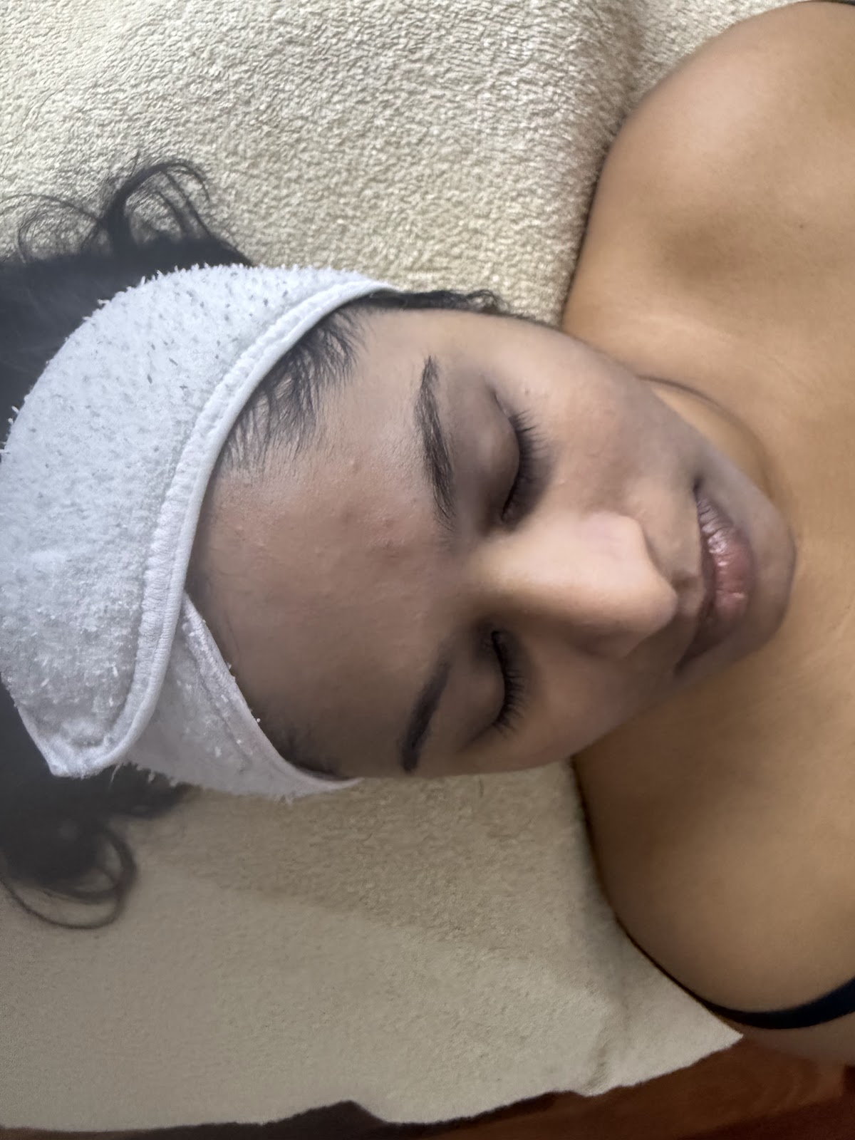 Client relaxing during facial